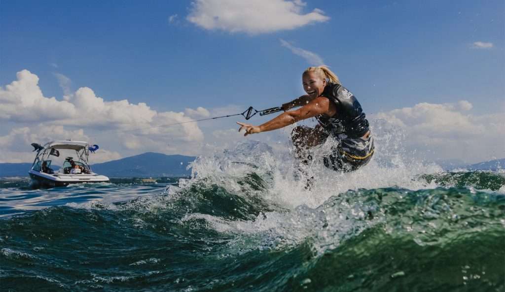 A vibrant image of Wake Bros Rentals' waterfront location bustling with activities, under a clear blue sky.