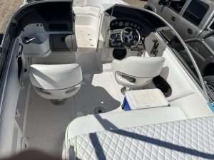 The Ebbtide 210 boat cruises on the water, showcasing its sleek design and performance.