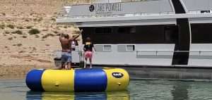 A large water trampoline set up at Lake Powell, available for rental fun and activities