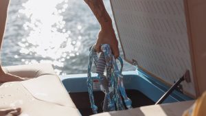 Person standing on back of boat, enjoying the view on Mastercraft NXT24 from Wake Bros Rentals