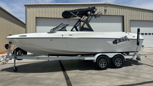 The AXIS T23 boat from Wake Bros Rentals, perfect for wakeboarding and water sports, shown on a calm lake.