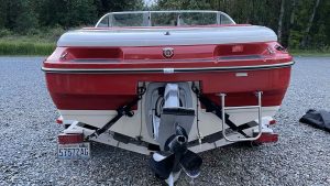Red and white boat with trailer attached at Wake Bros Rentals
