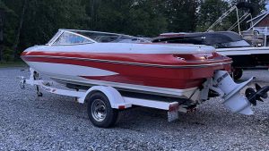 Boat on trailer in front of house