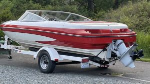 Boat on trailer parked in lot, ready for adventure.