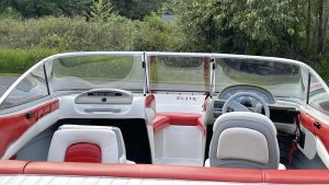 Boat with red and white seats and steering wheel -wake Bros Rentals