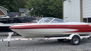 A boat parked on a trailer in front of a house at Wake Bros Rentals