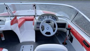 A Glastron boat with a steering wheel and dashboard at Wake Bros Rentals.