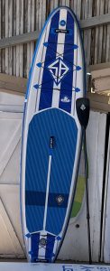 Blue and white paddle board with paddle. Perfect for a day on the water. Wake Bros Rentals.