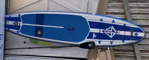 Stand-up paddle board in blue and white with paddle. Ideal for water adventures