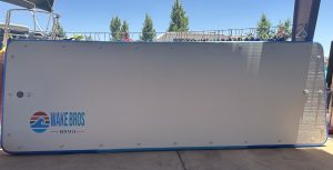 Blue Cross on white board, Wake Bros Rentals